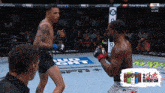 two men fighting in a boxing ring with a bud light advertisement in the background