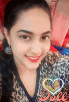 a girl with a leopard print shirt is smiling and has a heart in the background that says doll