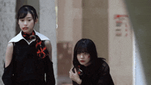a woman with blood on her face stands next to another woman with blood on her face