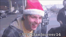 a man wearing a santa hat is smiling in a wwe fan forever 14 advertisement