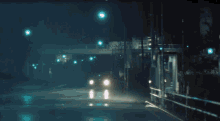 a car is driving down a street at night with a red light