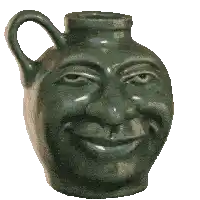 a green vase with a face on it