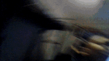 a blurry picture of a person in a dark room with a blue background