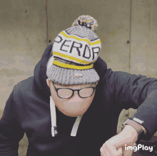 a man wearing glasses and a beanie that says peror on it