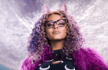 a woman with purple hair and glasses is wearing a purple fur coat and a cat costume .