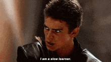 a young man in a leather jacket is talking to another man and saying `` i am a slow learner . ''