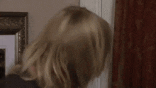 a woman with long blonde hair is giving a thumbs up with the words wow behind her