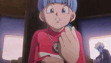 a girl with blue hair and a red shirt has a necklace that says c on it