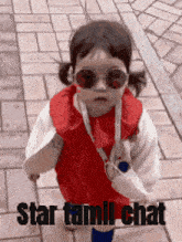 a little girl wearing sunglasses and a red dress is walking down a sidewalk with the words star tamil chat below her