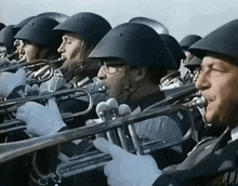 a group of soldiers are playing trumpets and wearing helmets