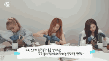 three women are sitting at a table with a sign that says twice beauty tv
