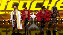 a group of wrestlers are standing in front of a yellow sign that says " lucha "