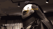 a stuffed animal with a yellow beak has a sticker on it that says ' lh '