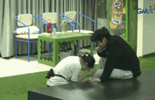 a man kneeling in front of a freeze machine