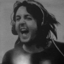a black and white photo of a man with headphones on