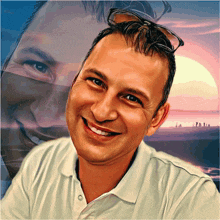 a man in a white shirt is smiling with a sunset behind him