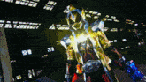 a man in a golden costume is holding a sword and shield