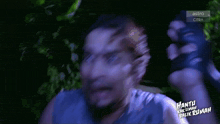 a man is screaming in front of a screen that says astro citra on it
