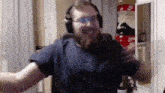 a man with a beard wearing headphones and glasses is dancing