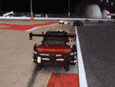 a manthey race car is on a track at night
