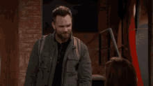 a man with a beard is standing next to a woman and saying " have a lovely day " .