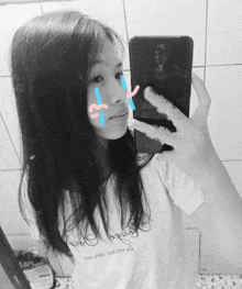 a girl is taking a picture of herself in a mirror with tears running down her face