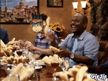 a group of people are sitting at a table with a monkey on their face and the word gif jif on the bottom right