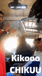 a group of people sitting on a train with the words kikooo chikuu