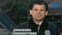 a man is wearing a jacket that says underdog productions on the front
