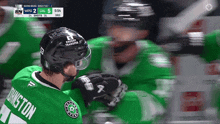 a hockey player wearing a green jersey with the name kingston on the back