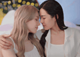 two women are touching their foreheads and the words lingorwolves are on the bottom of the image