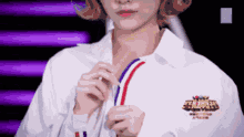 a woman wearing a white shirt with a logo on the back that says sns