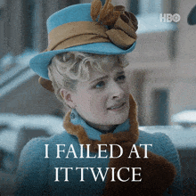 a woman wearing a hat and scarf says i failed at ittwice