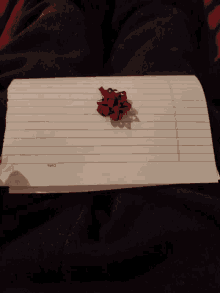 a piece of paper with a red bow on it that says ' i love you ' on it