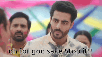 a man with a beard is standing in front of a crowd and says oh for god sake stop it !