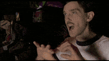 a man with a mustache is wearing a t-shirt that says " which is drop dead gorgeous "