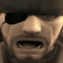a close up of a man 's face with a bandage on his eye and his mouth open .