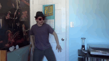a man is dancing in front of a poster that says hello hello