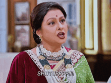 a woman wearing a necklace and earrings says shutuppp