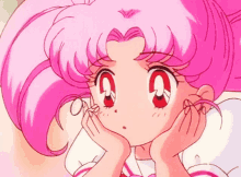 a close up of a pink haired anime character with a g on her face