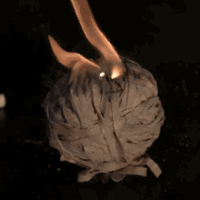a ball of white rubber bands is burning in the dark
