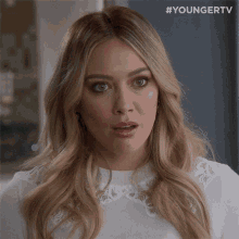 a close up of a woman 's face with a #youngertv watermark
