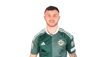 a man wearing a green adidas jersey flexes his arms