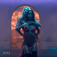 two women in bikinis are standing next to each other and the word him is on the bottom of the image