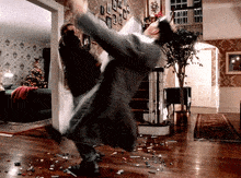 a man in a suit is kicking another man in the air