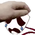 a hand is holding a cartoon character with a mustache and tears in his eyes .