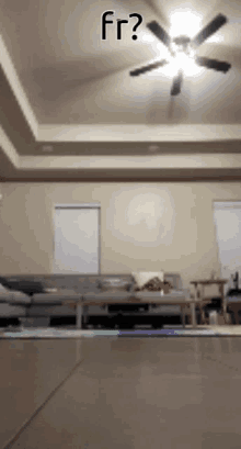 a living room with a ceiling fan and the words fr written on the bottom
