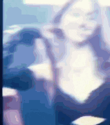 a blurred image of a person 's face with a blue background