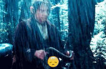 a man is standing in the rain holding a snake and a smiley face .