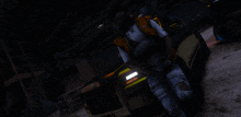 a man in an orange vest is standing in front of a black and yellow car